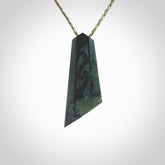 Hand made New Zealand Kawakawa jade toki with koru pendant. Hand carved in New Zealand by Rueben Tipene. Hand made jewellery. Unique large Jade Toki with adjustable cord. Free shipping worldwide.